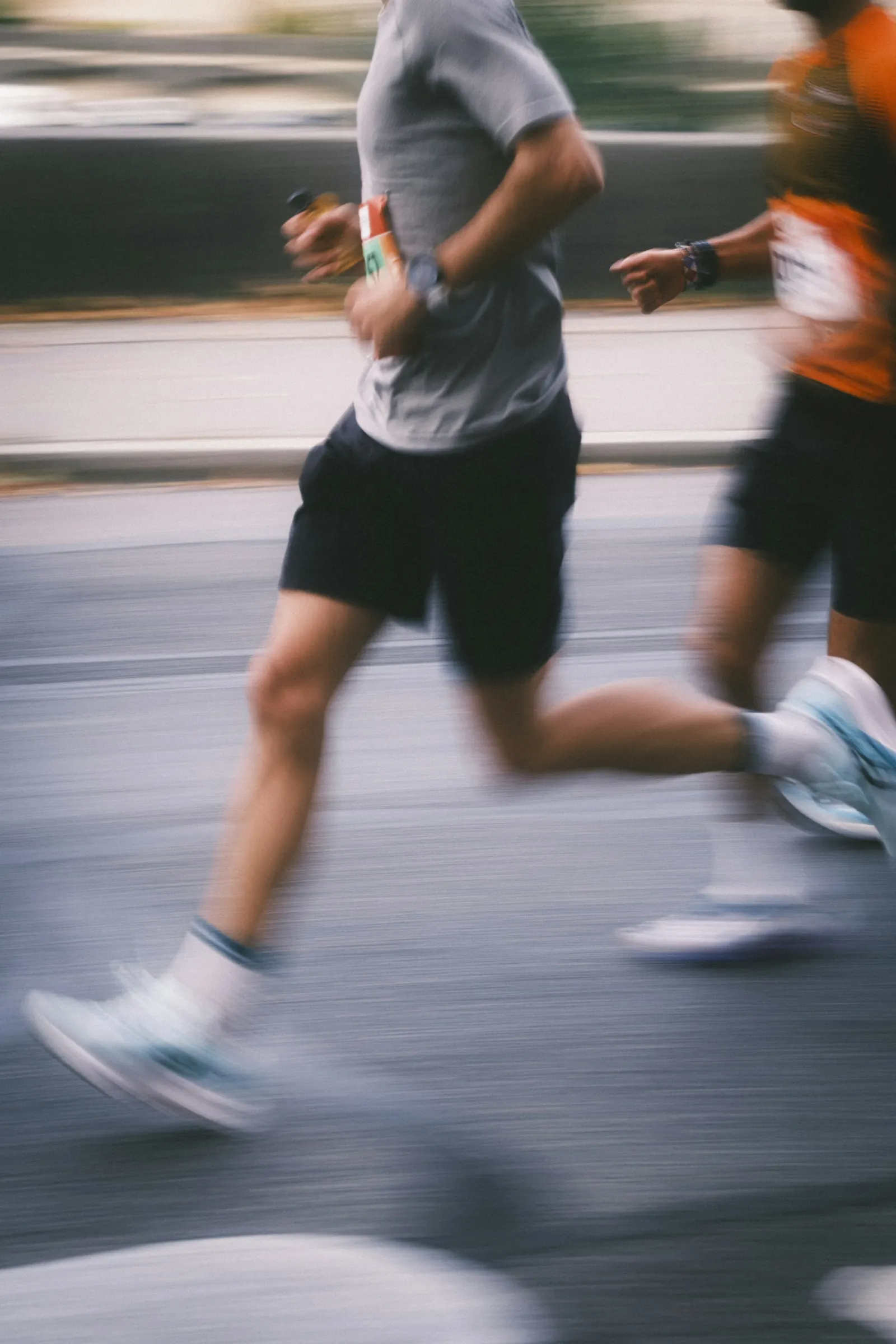 Runners in a road race, motion-blurred